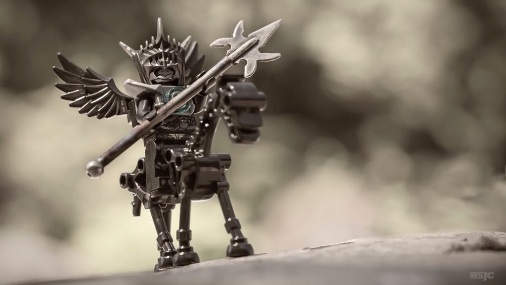 a LEGO black winged angle riding a black skeleton horse wields a large and deadly battle axe